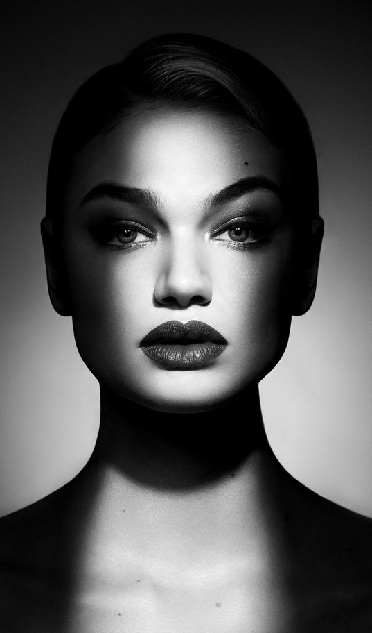 a black and white photo of a woman's face with dark lipstick on her lips