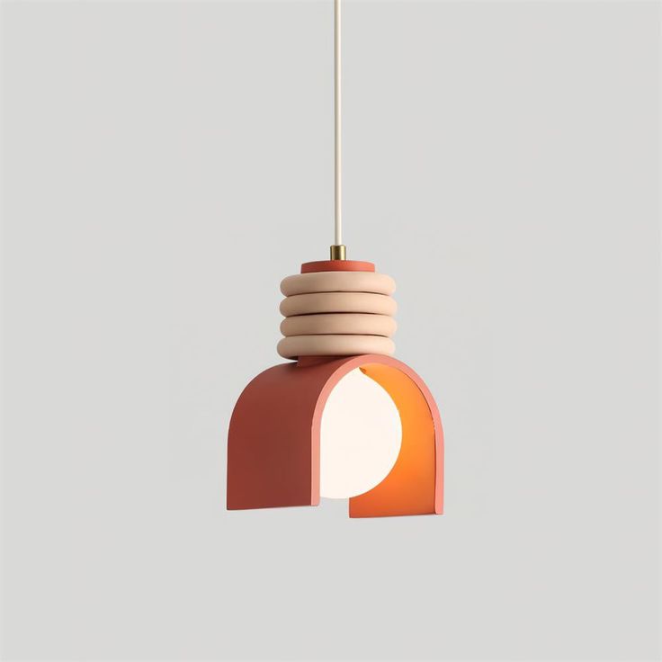 an orange and pink light hanging from a ceiling fixture with a white cord attached to it