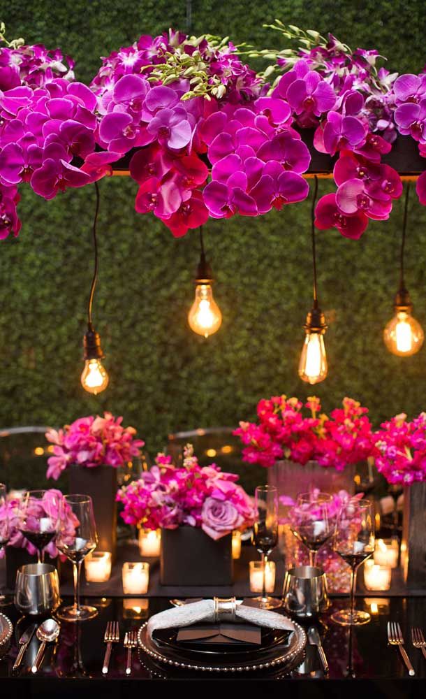 the table is set with purple flowers and candles