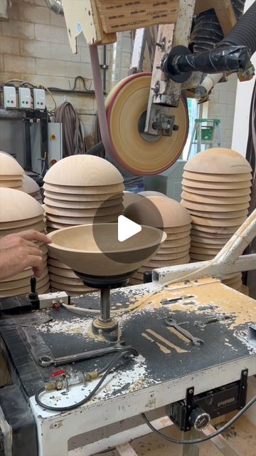 a man working on pottery in a shop