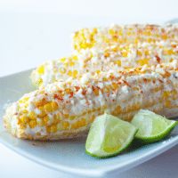 corn on the cob with limes and sour cream