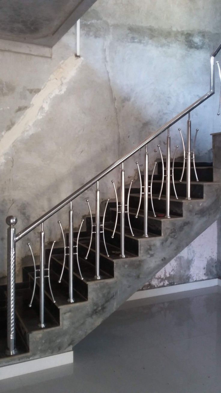 a set of stairs with metal handrails in a building