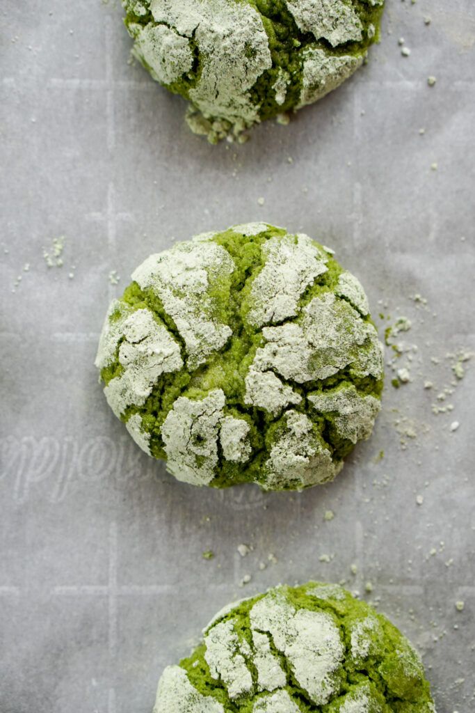 three cookies covered in green and white powder