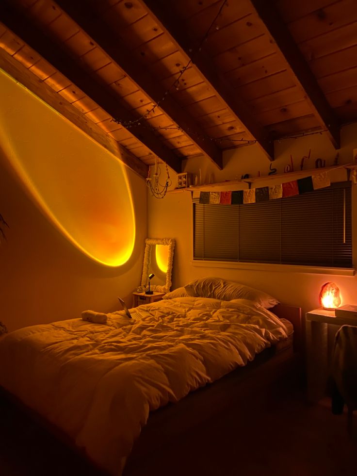 a bed in a room with a surfboard on the wall and lights above it