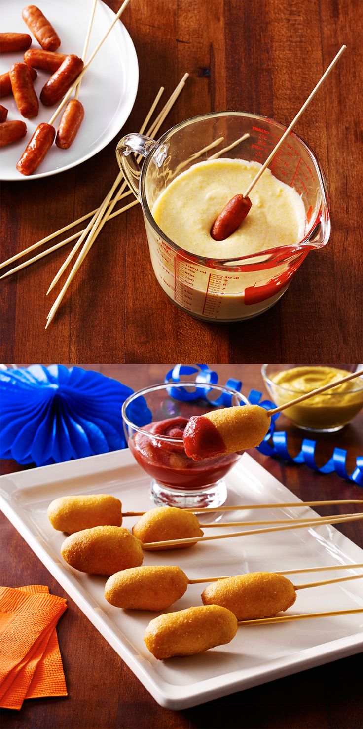 hotdogs on skewers with dipping sauce in a glass bowl and orange napkins