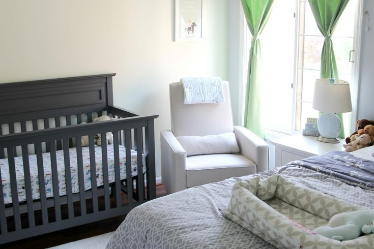 a baby's room with a crib, rocking chair and bed in it