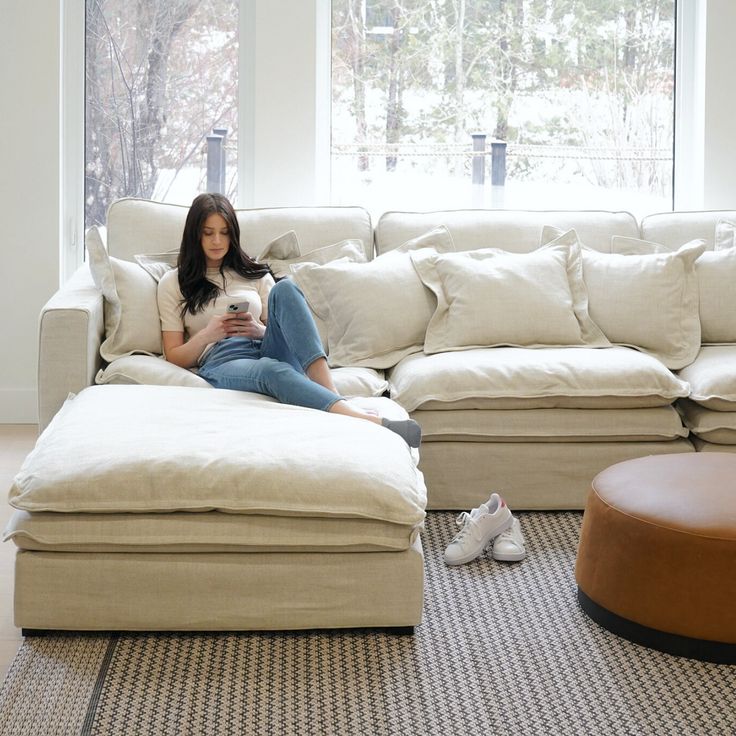 a woman sitting on top of a white couch