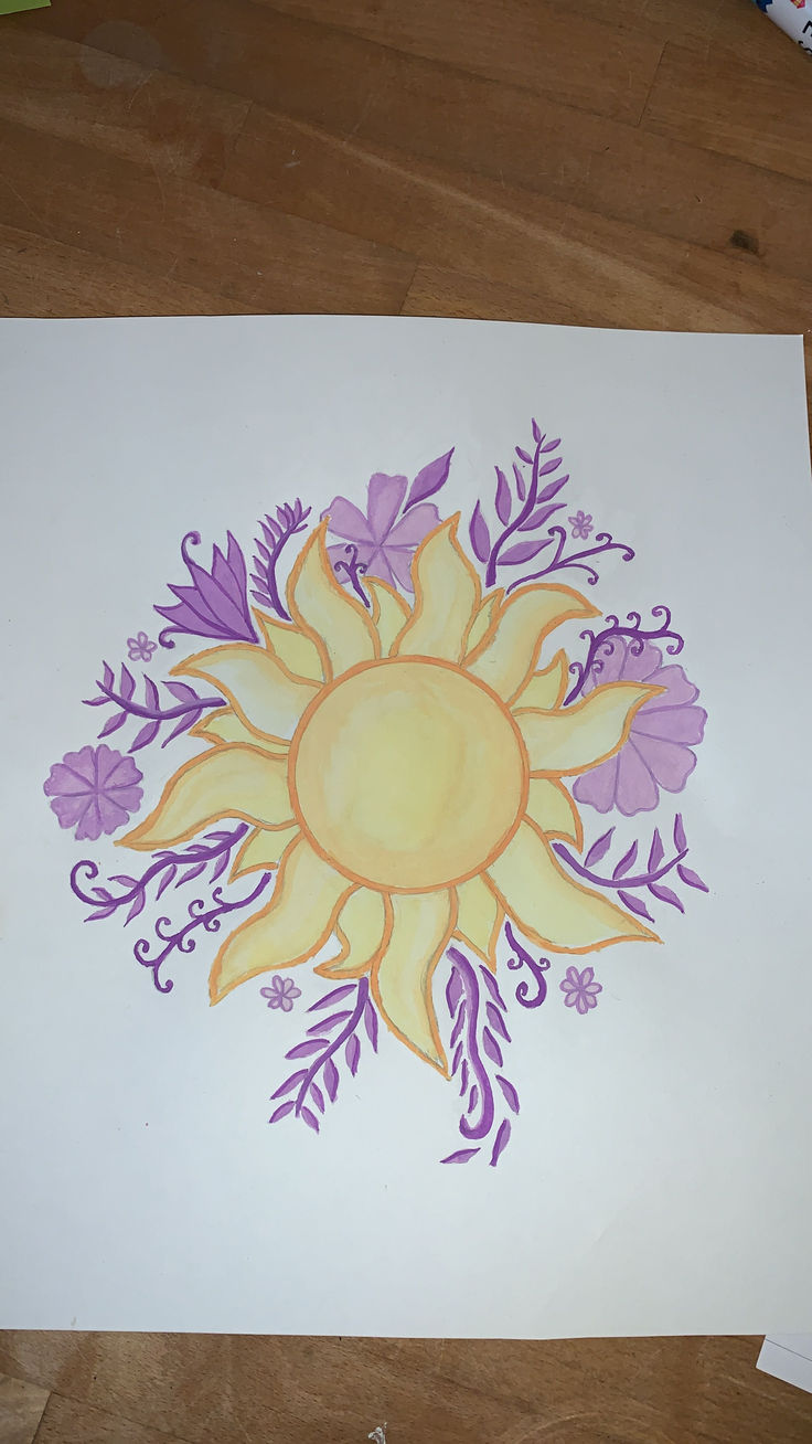 a drawing of a sun surrounded by purple and yellow flowers on a white piece of paper