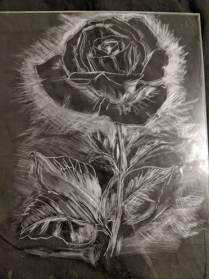 a black and white drawing of a rose