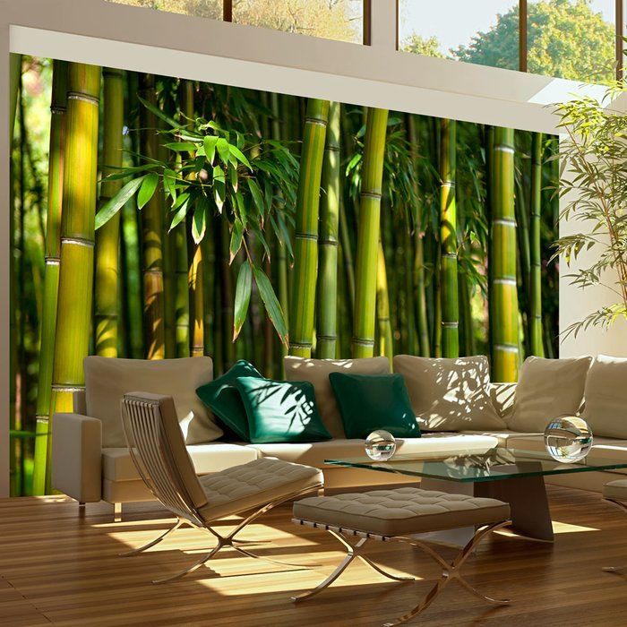 a living room with bamboo trees in the background