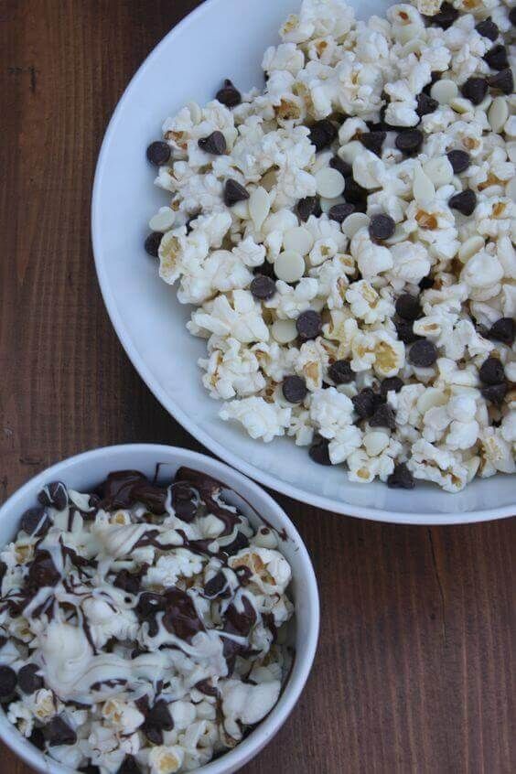 two bowls filled with popcorn and chocolate chips