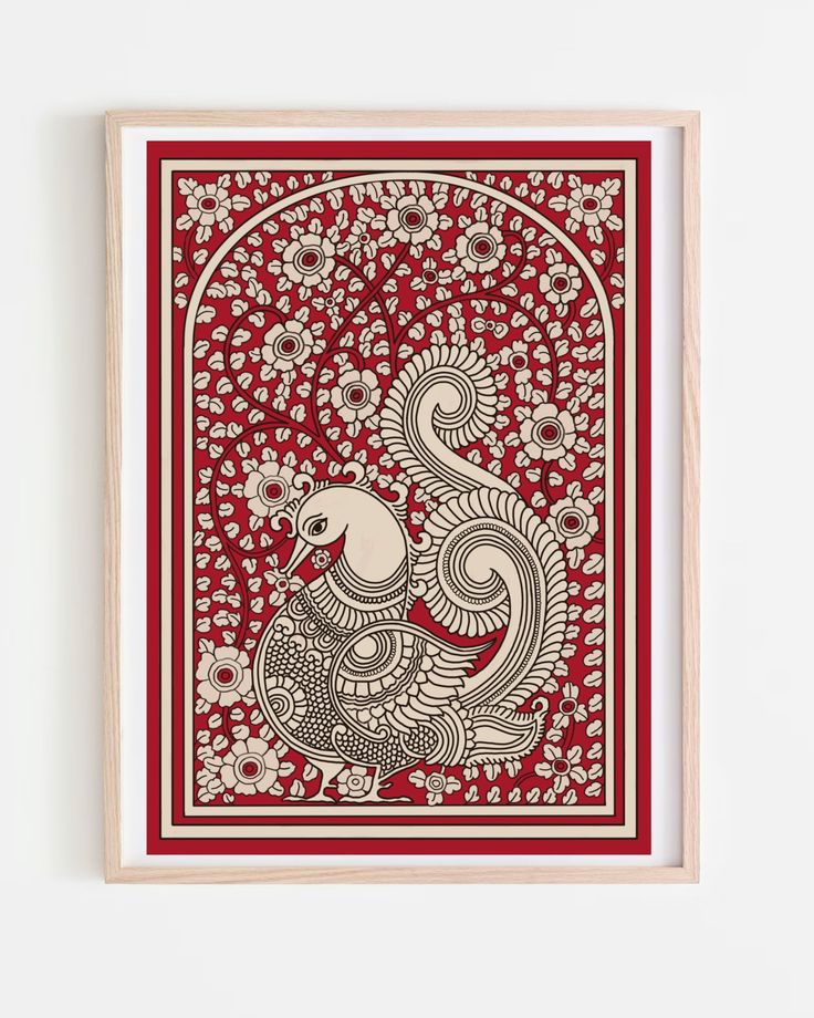 a red and white print with an intricate design on the front, in a wooden frame