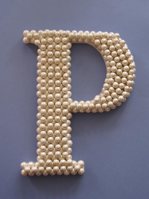 the letter p is made out of beads