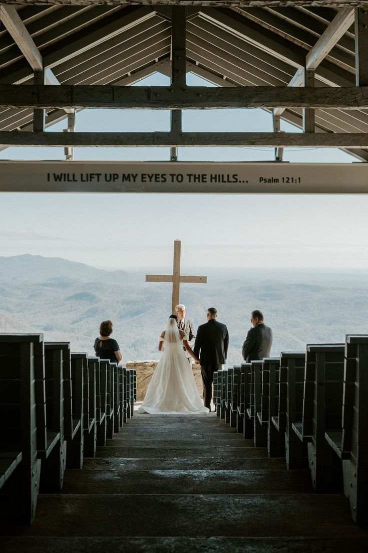 the bride and groom stand at the end of their aisle as they walk up to the altar