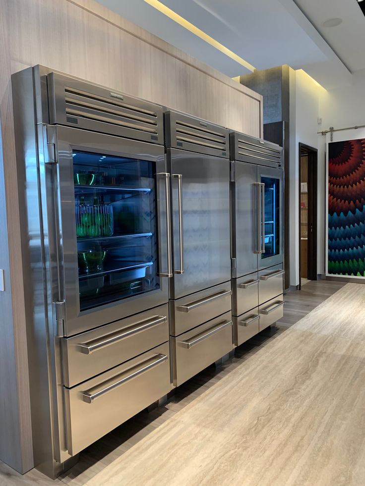 stainless steel refrigerators and cabinets in a large room