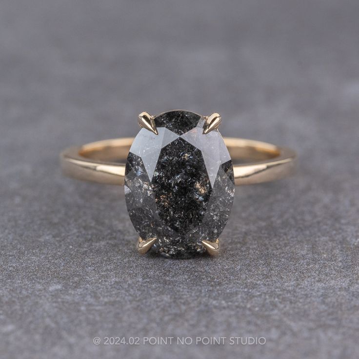 black diamond Black Sapphire Engagement Ring, Black Oval Diamond Cut Rings, Black Oval Rings With Diamond Accents, Grey Black Diamond Engagement Ring, Engagement Ring Basket, Black Speckled Diamond Engagement Ring, Black Speckled Diamond Ring, Black Engagement Rings, Black Stone Engagement Ring