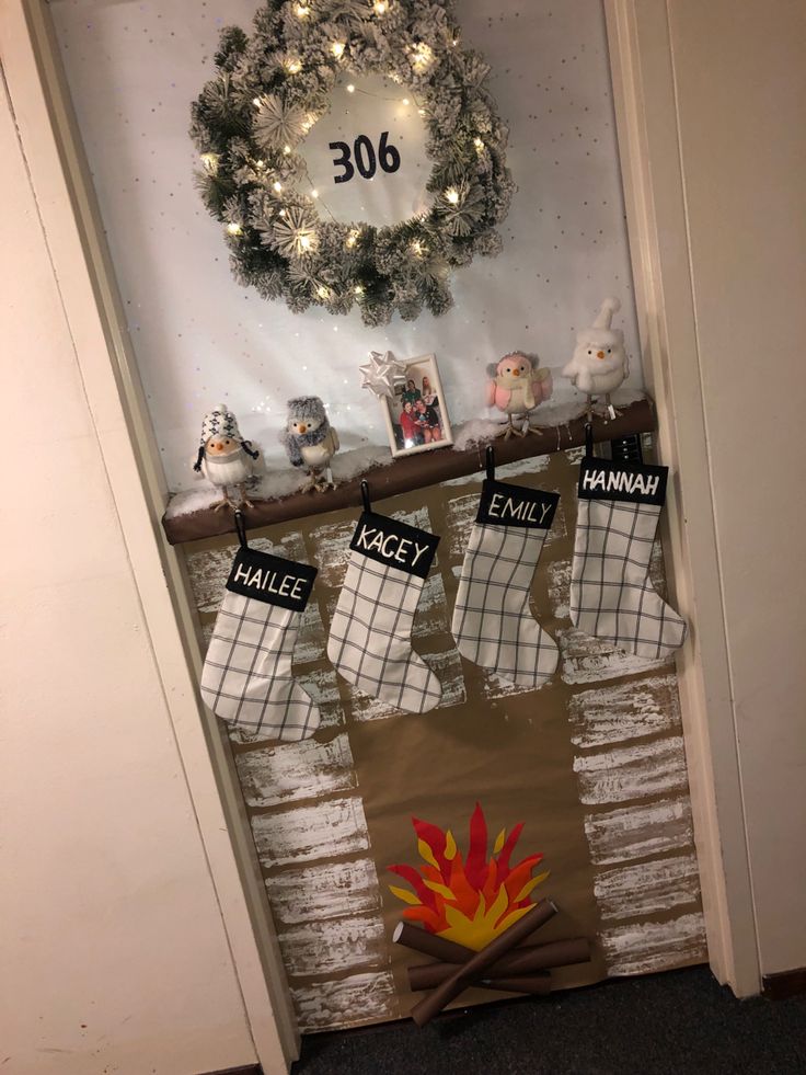 stockings hanging on the front door decorated for christmas with an image of a wreath and other holiday decorations