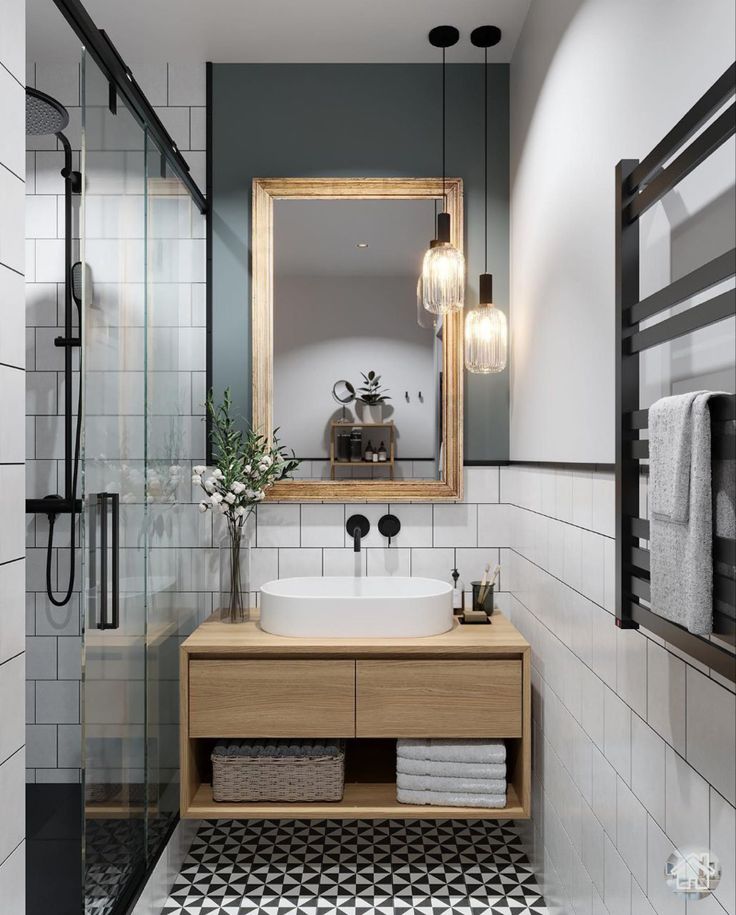 a bathroom with black and white flooring and a large mirror above the sink on the wall