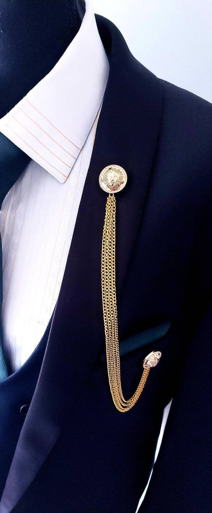 Looking for an elegant and distinctive accessory to elevate your style? Add charm and sophistication to your look with our Elegant Lion Lapel Pin Badge with Gold Chains! It is a masterpiece that'll have you strutting like royalty. It is a fantastic way to give the finishing touch to your outfit. Its striking design and gold chains naturally match your style, making it a remarkable item. Its versatile elegance makes it a timeless treasure for anyone who wants to add a touch of sophisticated swagg Formal Metal Curb Chain Jewelry, Elegant Metal Curb Chain Jewelry, Luxury Silver Lapel Pin For Party, Elegant Metal Jewelry With Curb Chain, Metal Curb Chain Jewelry For Formal Occasions, Elegant Ceremonial Metal Jewelry, Elegant Formal Jewelry With Brooch, Elegant Formal Lapel Pin With Chain, Elegant Chain Lapel Pin For Formal Occasions