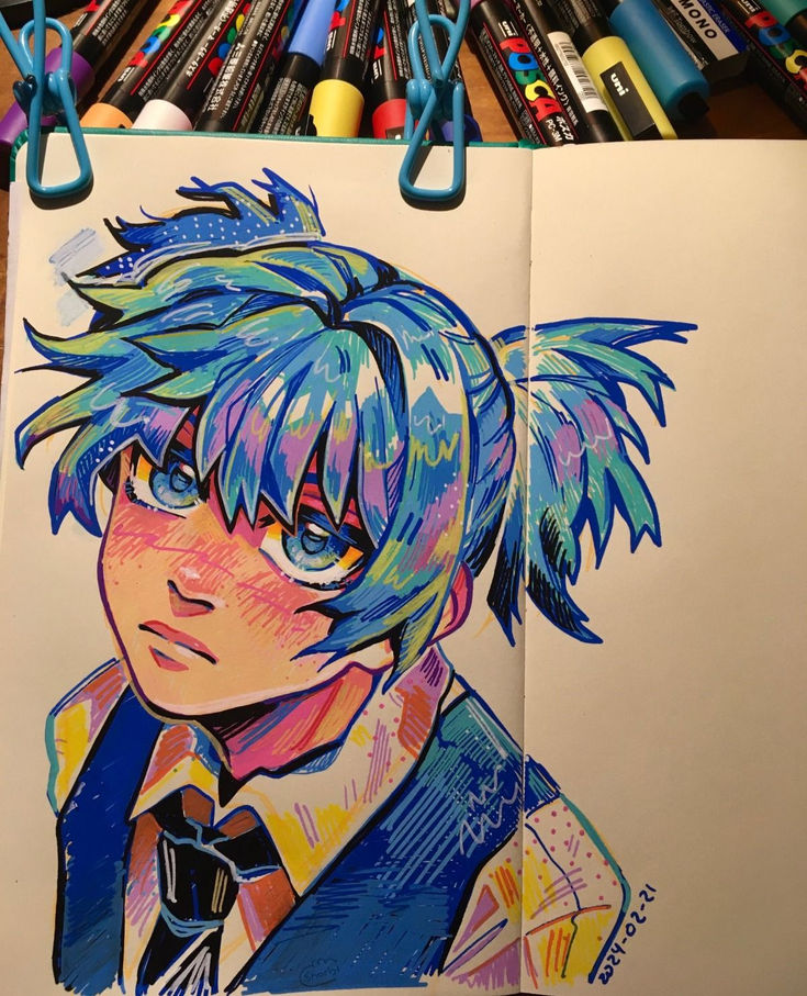 a drawing of an anime character with blue hair and bright colors on paper next to colored crayons