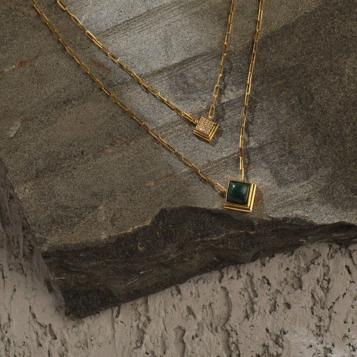 Description Inspired by the beautifully patterned Malachite gemstone, the earliest ore of copper, Tamra is eccentric, contemporary, and distinctively classy. Handcrafted on 925 hallmark silver and gold finish. This collection is curated for everyday luxury. This dual-layer chain necklace features a square-cut malachite charm and a square CZ charm suspended from a delicate chain. A striking necklace to style with Paksha's unmatched delicate jewelry. Product Information Materials used: 925 Silver Timeless Gold Emerald Necklace, Luxury Polished Emerald Jewelry, Minimalist Gold Emerald Gemstone Necklace, Gold Plated Emerald Necklace Fine Jewelry, Elegant Square Pendant Jewelry With Natural Stones, Elegant Jewelry With Square Pendant Natural Stones, Gold Plated Emerald Necklace In Fine Jewelry Style, Dainty Gold Emerald Necklace For Formal Occasions, Elegant Square Pendant Necklace With Natural Stones