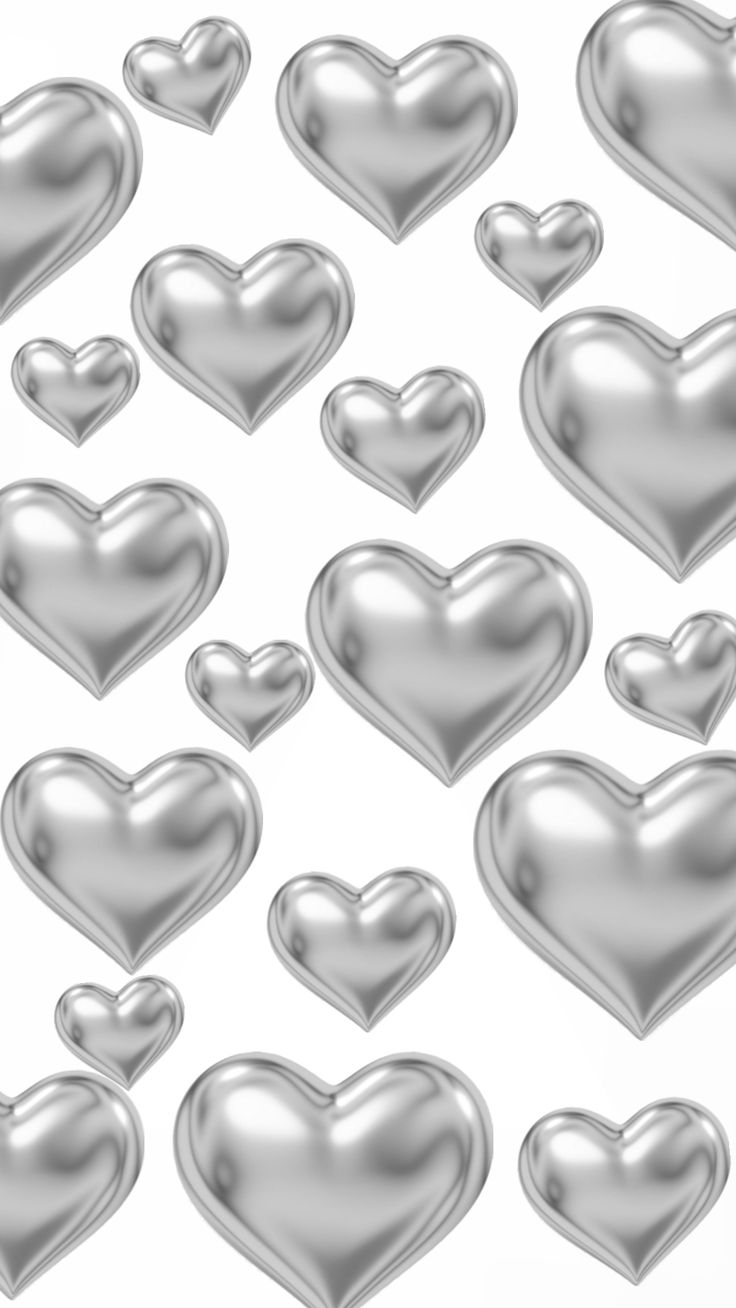 silver hearts are arranged in the shape of heart shapes