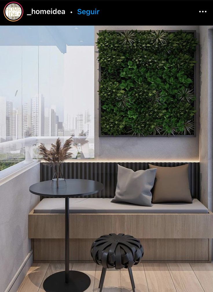 a room with a bench, table and plants on the wall above it is an indoor seating area