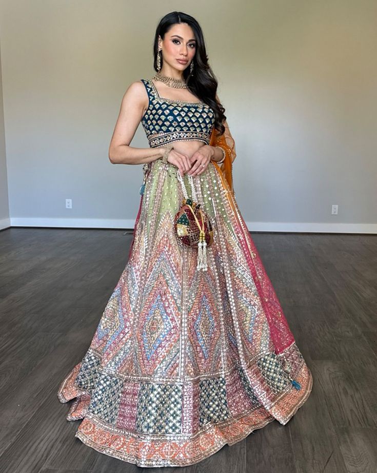 A light lehenga adorned with multicolor foil embroidery. It is paired with a hand-embroidered blouse with side cutouts and an ombre orange to pink dupatta. DELIVERY TIMEPlease allow 8-12 weeks for your outfit to arrive. FABRIC DETAILSNet. Light Lehenga, Pink Dupatta, Yellow Lehenga, 12 Weeks, V Neck Blouse, Embroidered Blouse, Skirt Length, Lehenga, Hand Embroidered