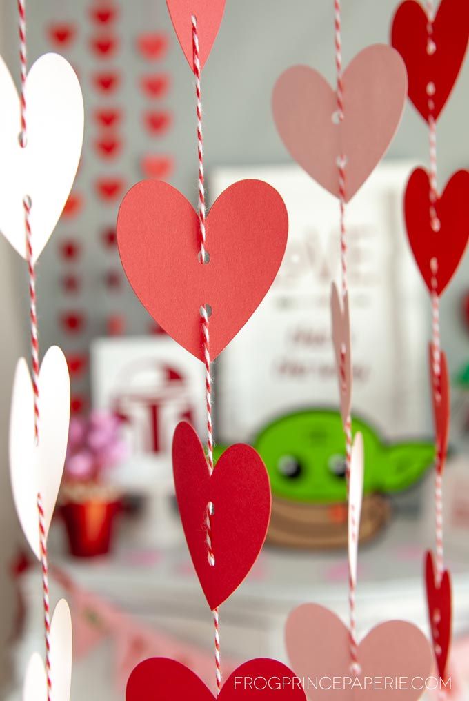 paper hearts hanging from a string on a table