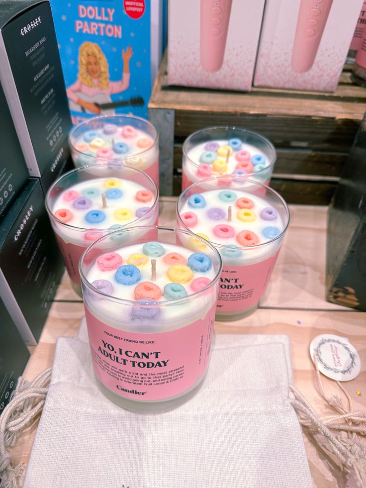 three candles sitting on top of a table next to a box of doughnuts