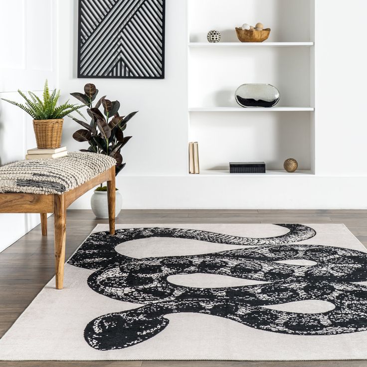 a black and white area rug in the middle of a room with bookshelves