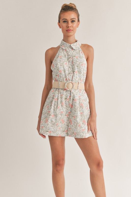 Embrace the bloomy side of life with our Floral Print Romper with Belt. This versatile design is your ticket to a stylish and comfortable look this summer. With a stunning floral print that exudes freshness, a flattering halter neckline, and a belt to cinch around the waist, this romper is a must-have in your wardrobe. Stay organized and stylish with convenient pockets to store your essentials while you take on your next adventure. Unleash your wild side and live life to the fullest in this chic Chic Floral Print Halter Top For Day Out, Feminine Spring Halter Top For Beach, Feminine Summer Halter Top For Day Out, Feminine Spring Vacation Halter Top, Feminine Halter Top For Spring Vacation, Feminine Halter Neck Top For Vacation, Feminine Sleeveless Halter Top For Summer, Casual Floral Print Halter Top For Beach, Chic Floral Print Halter Top