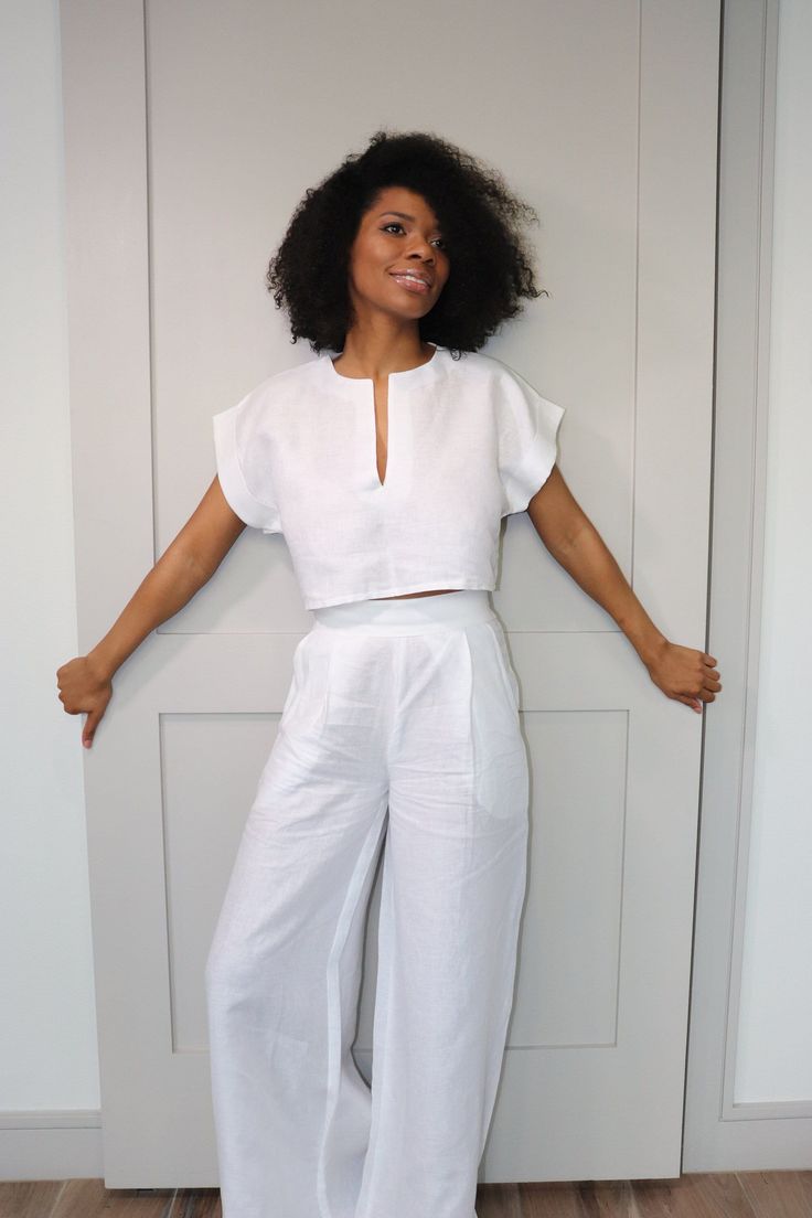 Our white slit neck is a must have. Whether you're strolling along the beach, attending a casual gathering, or simply enjoying a leisurely day out, this white Linen slit Crop Top Set is the epitome of laid-back elegance. Embrace the carefree spirit of summer and make a bold style statement with this unique ensemble. Crafted with utmost care and attention to detail, this set features a delightful combination of high-quality materials, pockets, and exquisite craftsmanship. The soft, breathable organic linen fabric, known for its lightweight nature and exceptional durability, ensures a luxurious feel against your skin while keeping you cool during warm summer days. This piece is also available in 20 other colors as show in the images. Please select your preferred color or just leave a note at Linen Chic Outfit, Crop Tops Linen, White Pants Set Outfit, Colored Linen Pants Outfit, Two Piece Linen Set Women, White Linen Set Outfit, Summer Linen Set, Linen Sets Outfit, White Linen Dress Outfit