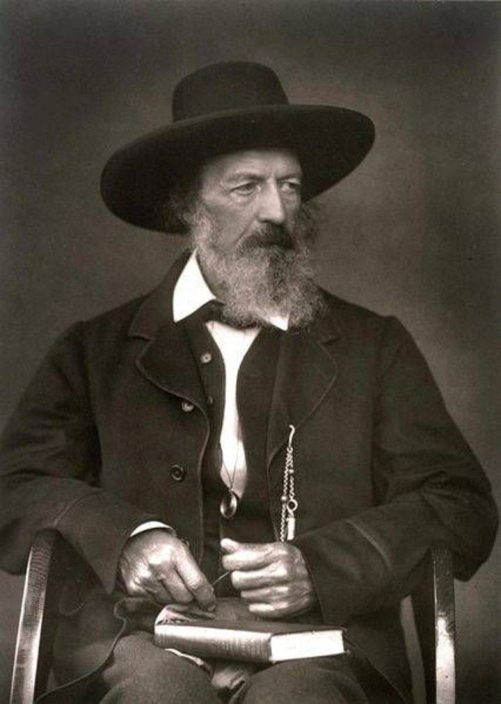 an old black and white photo of a man with a long beard wearing a hat