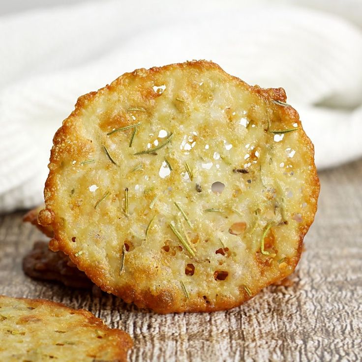 two crackers sitting on top of a wooden table next to a white towel and napkin