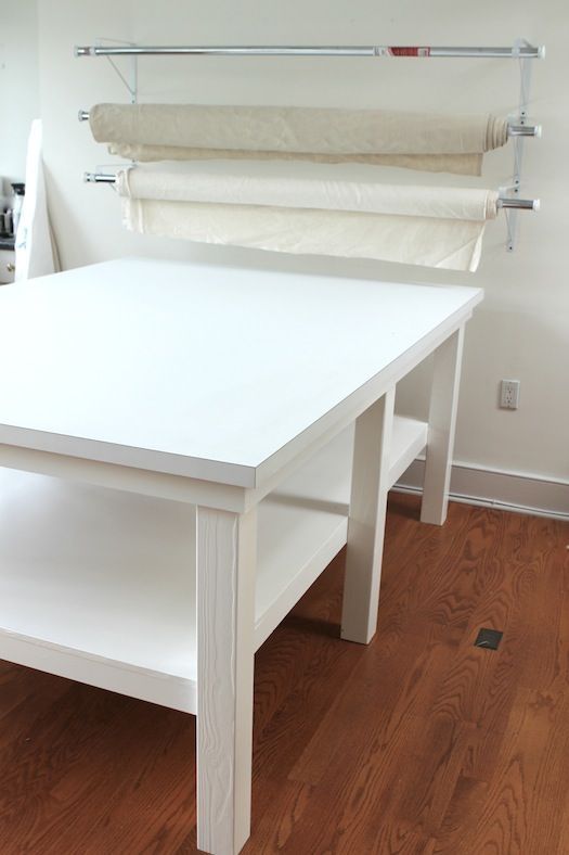 a white table and bench in a room