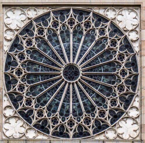 an intricately designed window on the side of a building