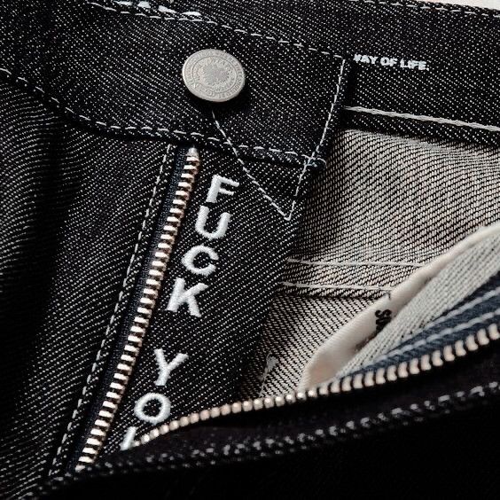 black and white photograph of the back pocket of a pair of jeans that say, tokyo