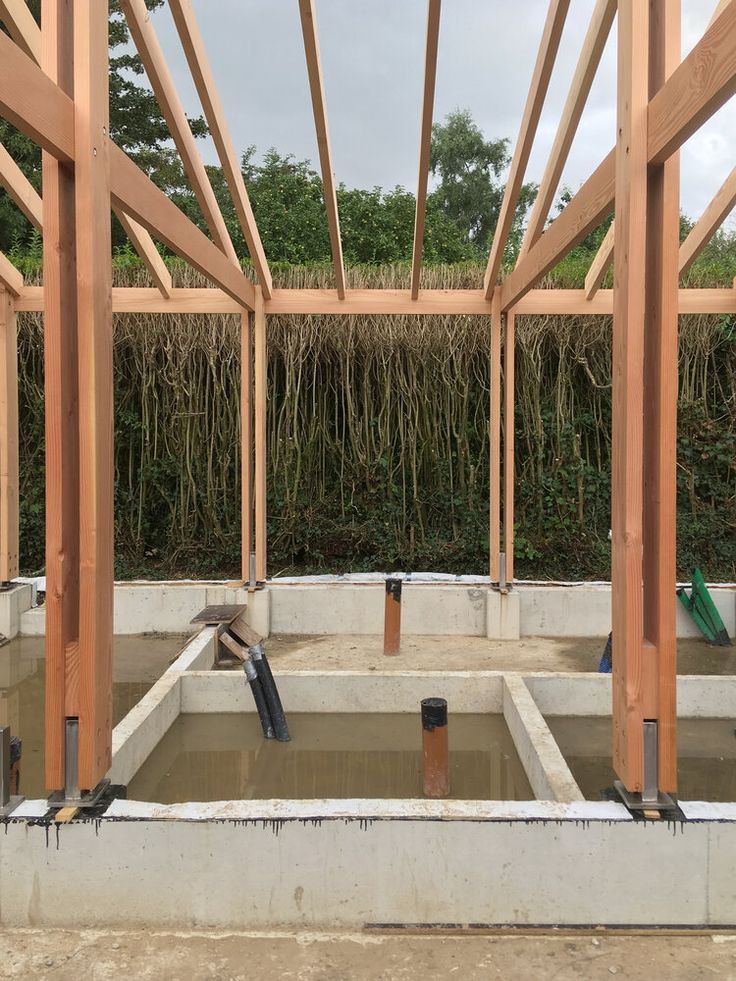 the inside of a building being built with wood framing and concrete floor joisting