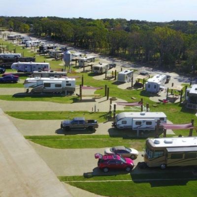 an aerial view of rv park with parked cars and motorhomes in the background