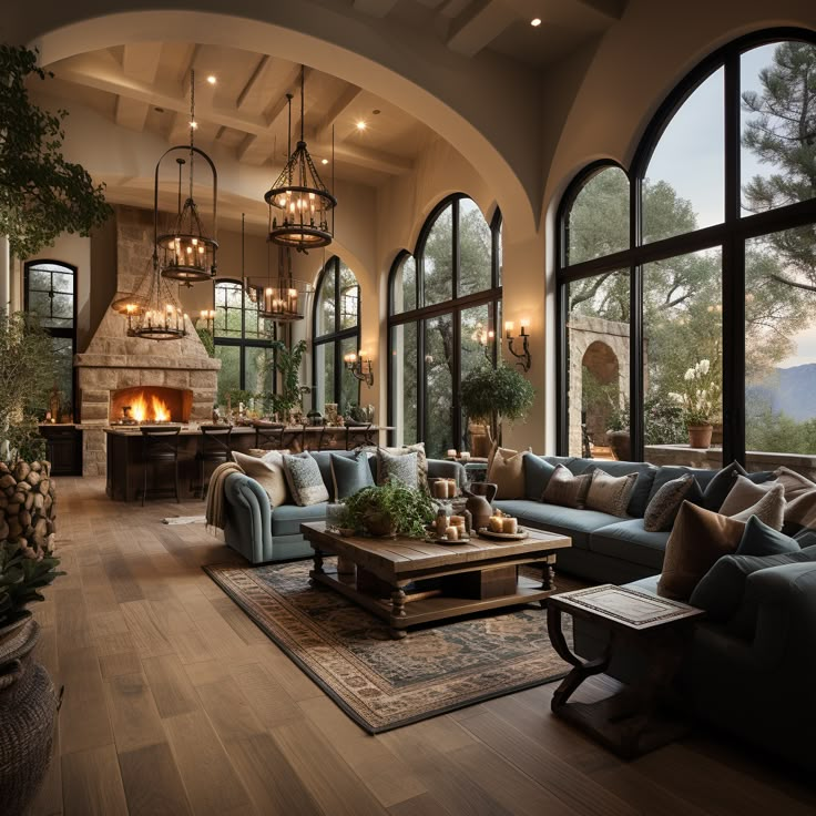 a living room filled with lots of furniture next to large windows and a fire place