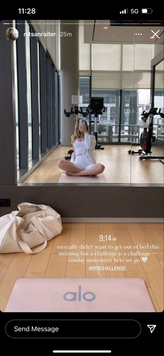 a woman is sitting on the floor in front of a mirror and doing yoga exercises