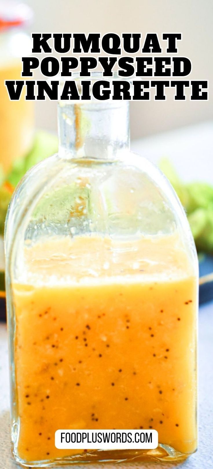 a glass bottle filled with liquid sitting on top of a table next to vegetables and sauce