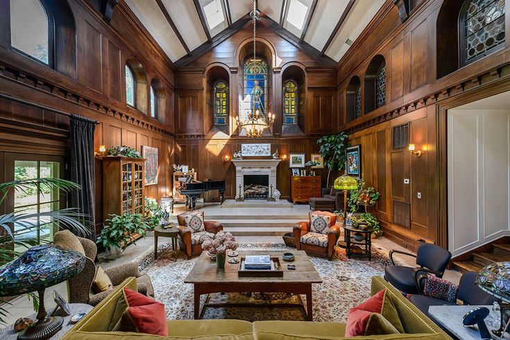 a large living room with wood paneling and high ceilings