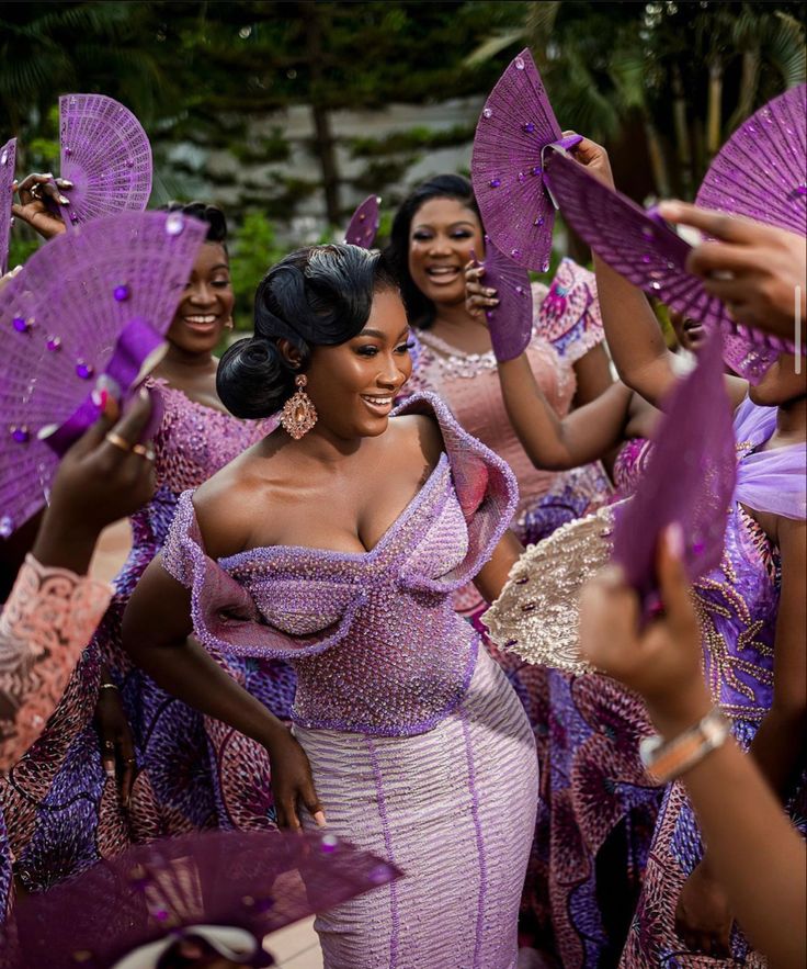 a group of women dressed in purple dance around each other