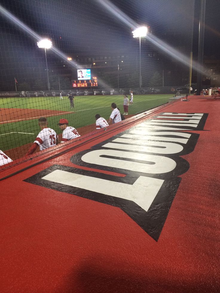 some baseball players are sitting on the bleachers in the dark and waiting for their turn to play