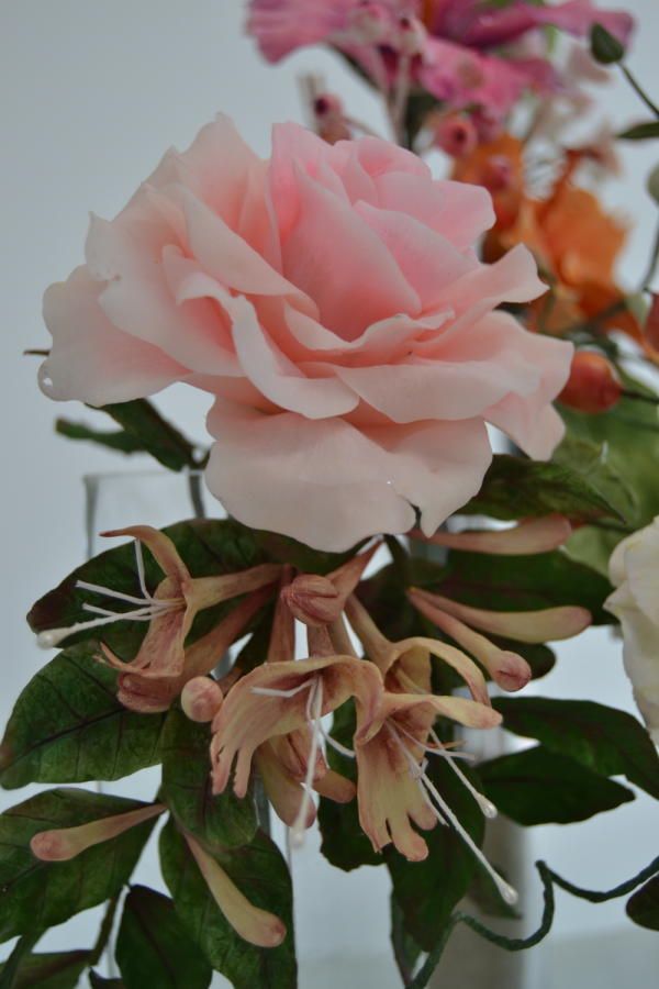 a vase filled with pink and white flowers