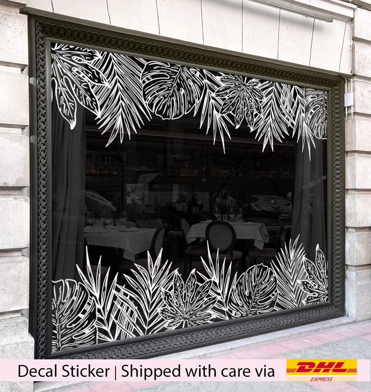 an image of a restaurant window with palm leaves on it