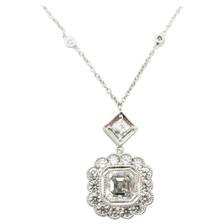 Platinum and 14K white gold GIA certified asscher and round diamond bezel set necklace. Centering one asscher cut GIA certified diamond weighing approximately 1.00 carat. Diamond grading: color grade: G. Clarity grade: VS2. Displaying one Asscher cut diamond, prong set in an illusion square style setting, weighing approximately 0.13 carats. Interspersed with 14 round brilliant cut diamonds on the pendant itself and an additional 14 round brilliant cut bezel set diamonds on the chain, weighing ap Round Diamond Pendant, Bezel Set Necklace, Pendant Ideas, Platinum Chain, Horseshoe Necklace, Asscher Cut Diamond, Pendant Diamond, Round Necklace, Bezel Set Diamond