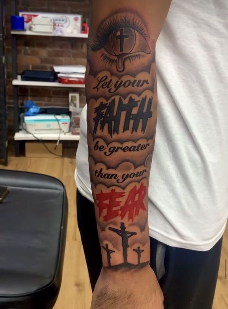 a man's arm with the words let your faith be greater than your fear